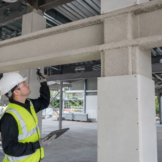 What A Structural Steel Fire Protection Inspection Should Include Fire engineer comparing a steel beam on what a Structural Steel Fire Protection Inspection should include